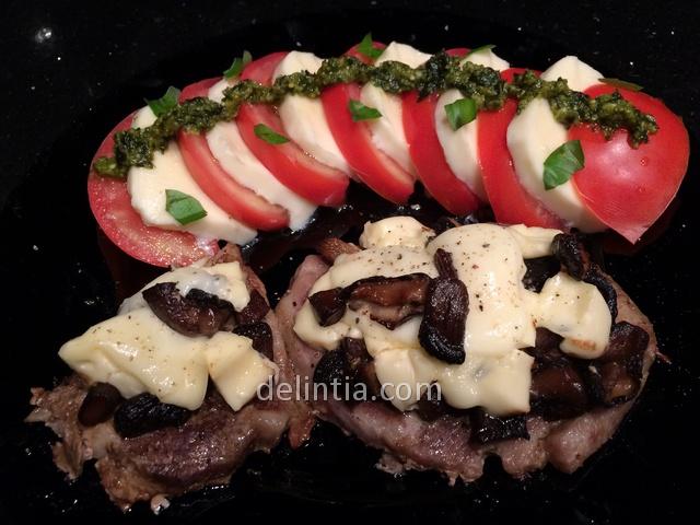Pork steak with mushrooms and melted cheese