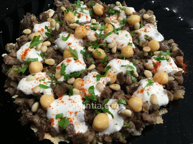 Arab dish with lamb meat, pita bread, chickpeas and yogurt sauce